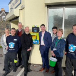 Members of the Donate 4 Defibs team by a public access debribrillator