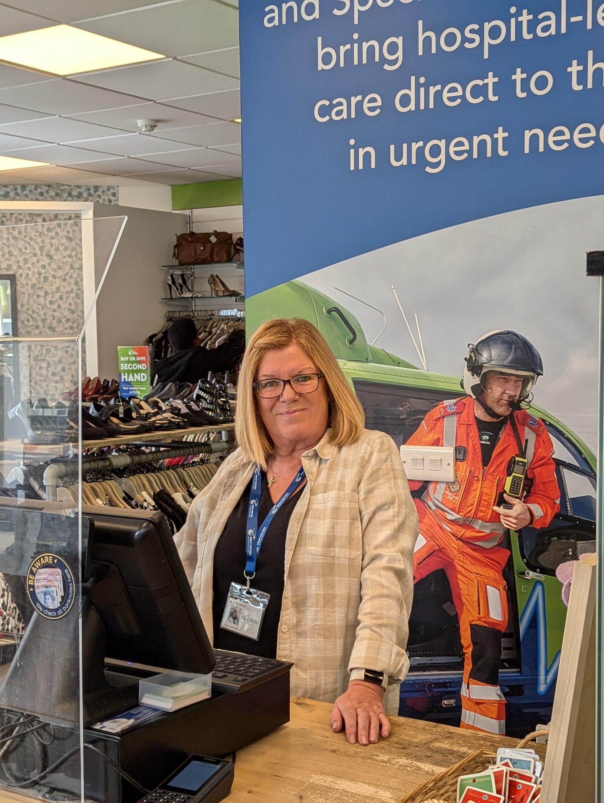 Lesley posing behind the till at Westbury-on-Trym shop