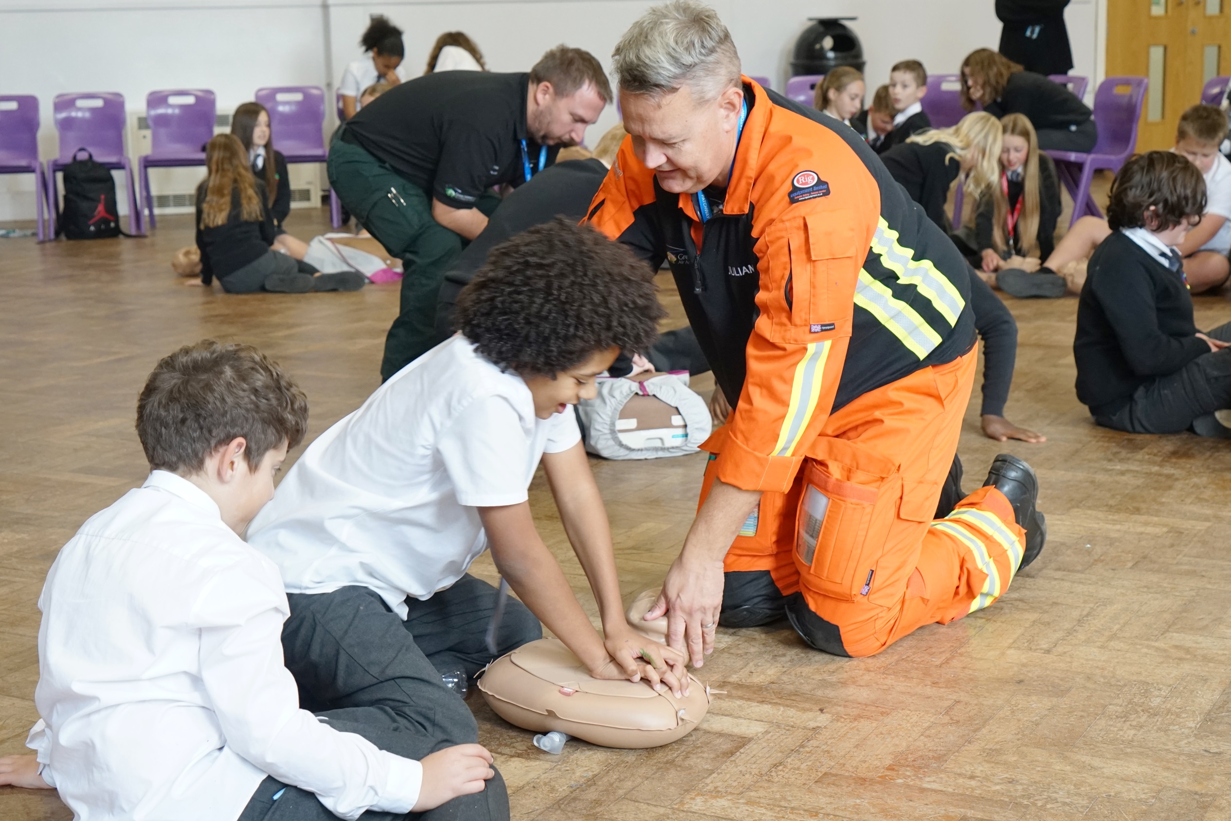 A GWAAC Critical Care Doctor teaches a child CPR