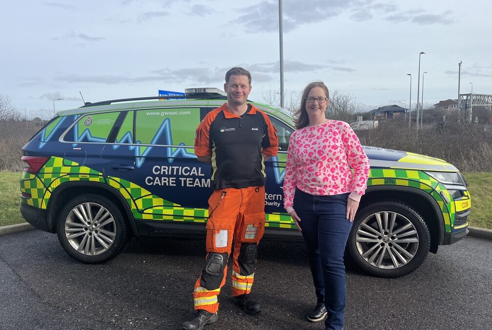 Former patient Rhiannon meeting SPCC Mark in front of a GWAAC critical care car
