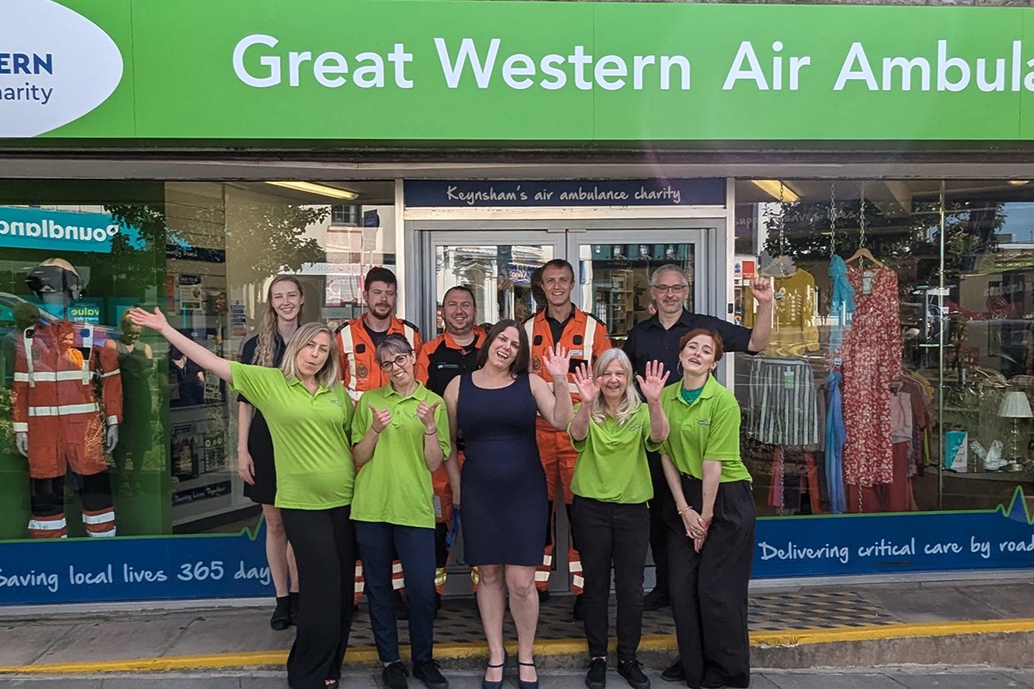 Great Western Air Ambulance crew, shop team and supporters celebrating in front of a new shop