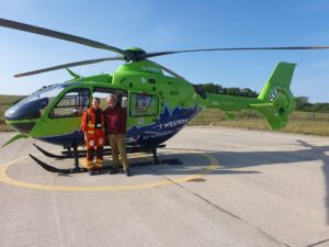 Mark Horton and Doctor Celestine by the GWAAC helicopter