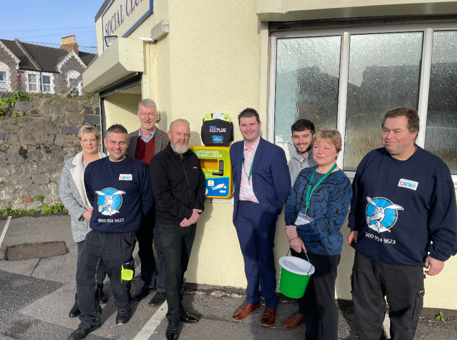 Members of the Donate 4 Defibs team by a public access debribrillator