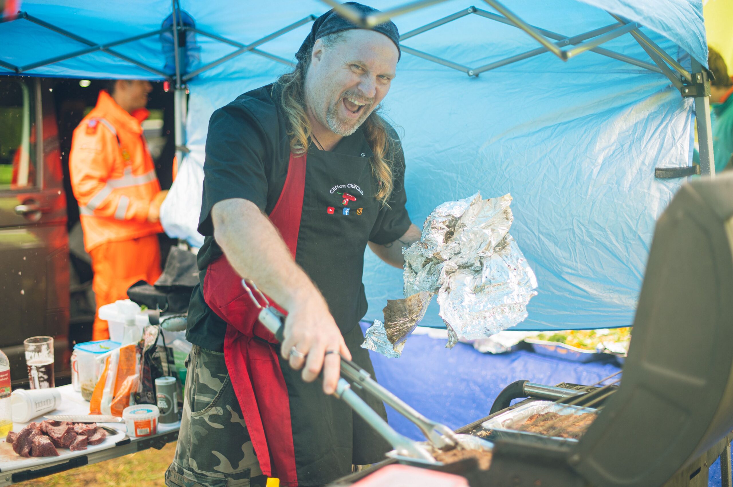 Jay operates his tongs at the BBQ.