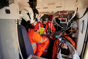 SPCC Dee and Critical Care Doctor Rich monitor an intubated patient in the back of our helicopter