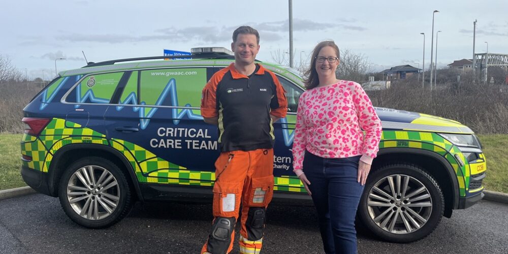 Former patient Rhiannon meeting SPCC Mark in front of a GWAAC critical care car