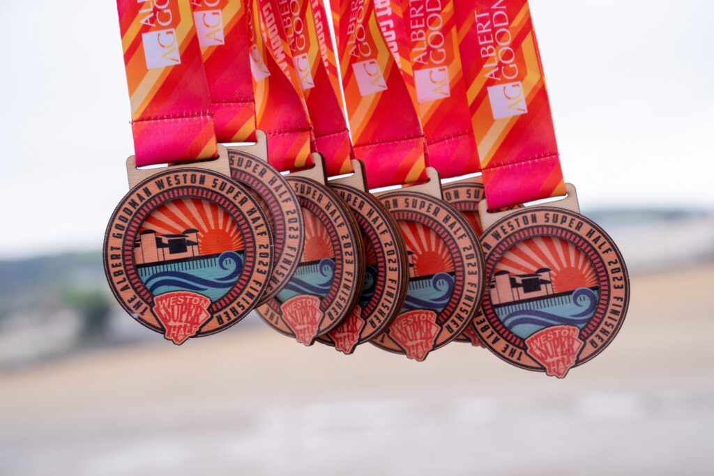 A row of finisher medals for the Weston Super half marathon