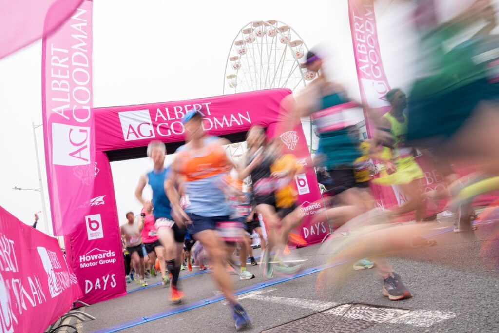 The start line of the Weston Half Marathon, with runners speeding past in a blur