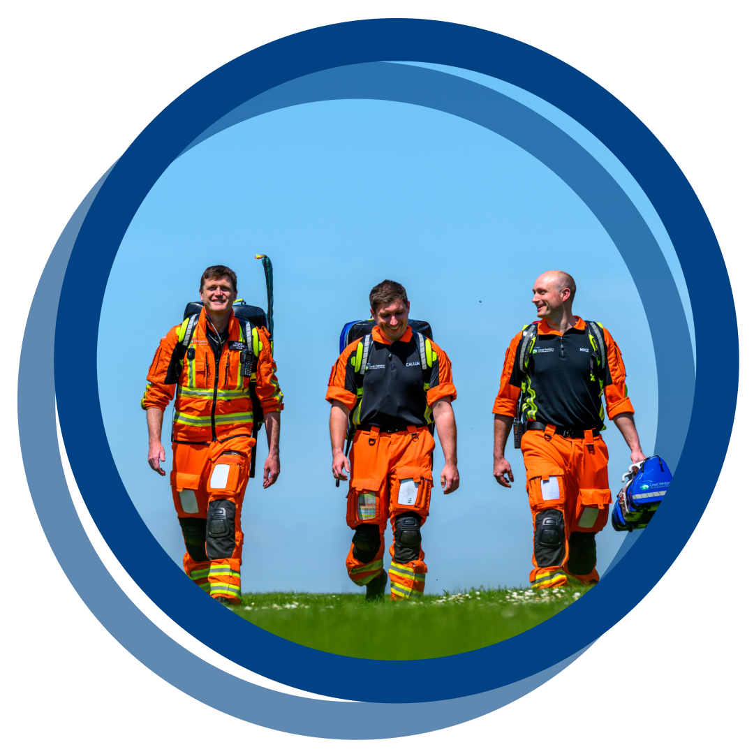 Three crew members walking across a field