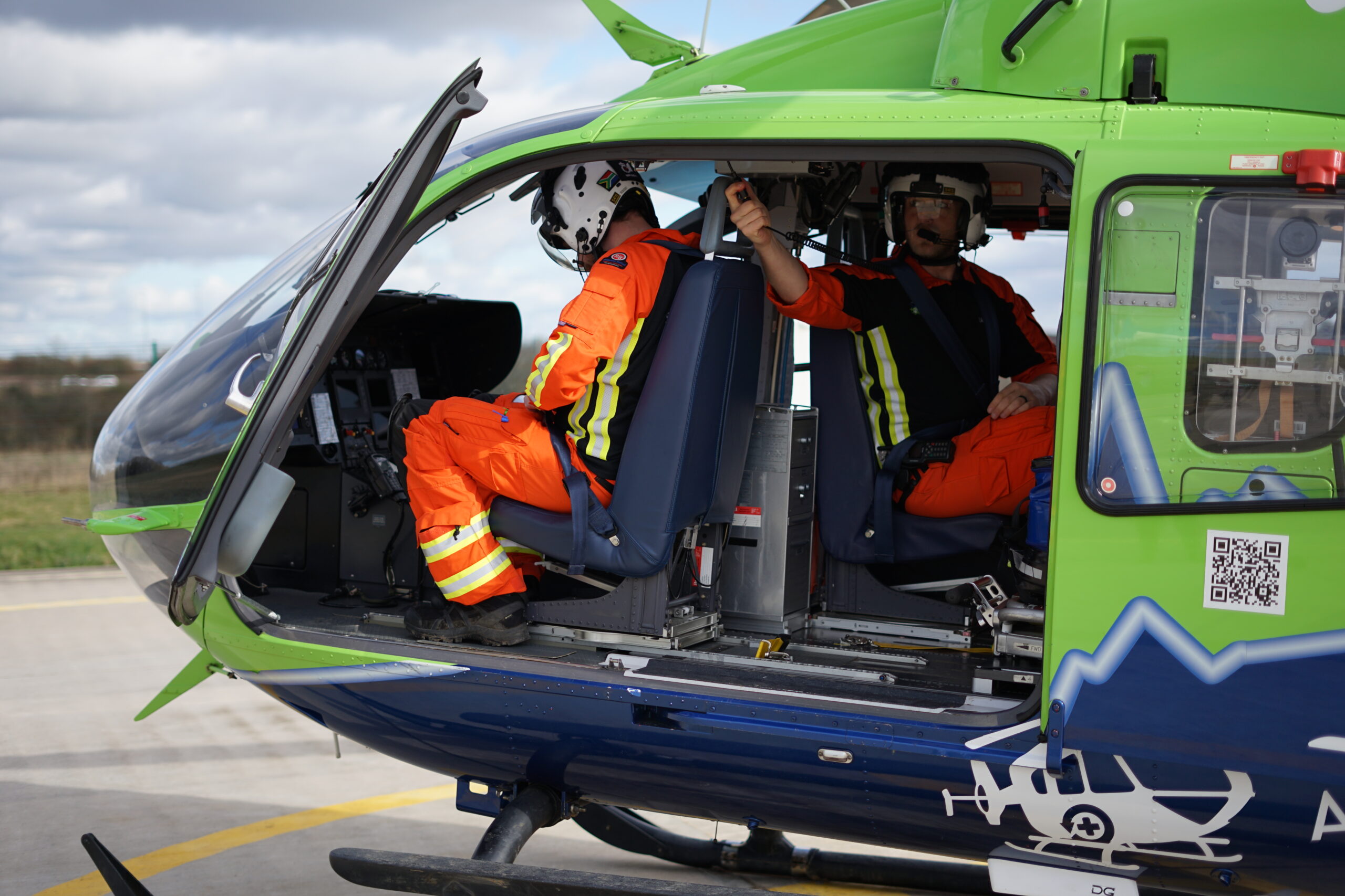 two SPCCs sitting inside the helicopter