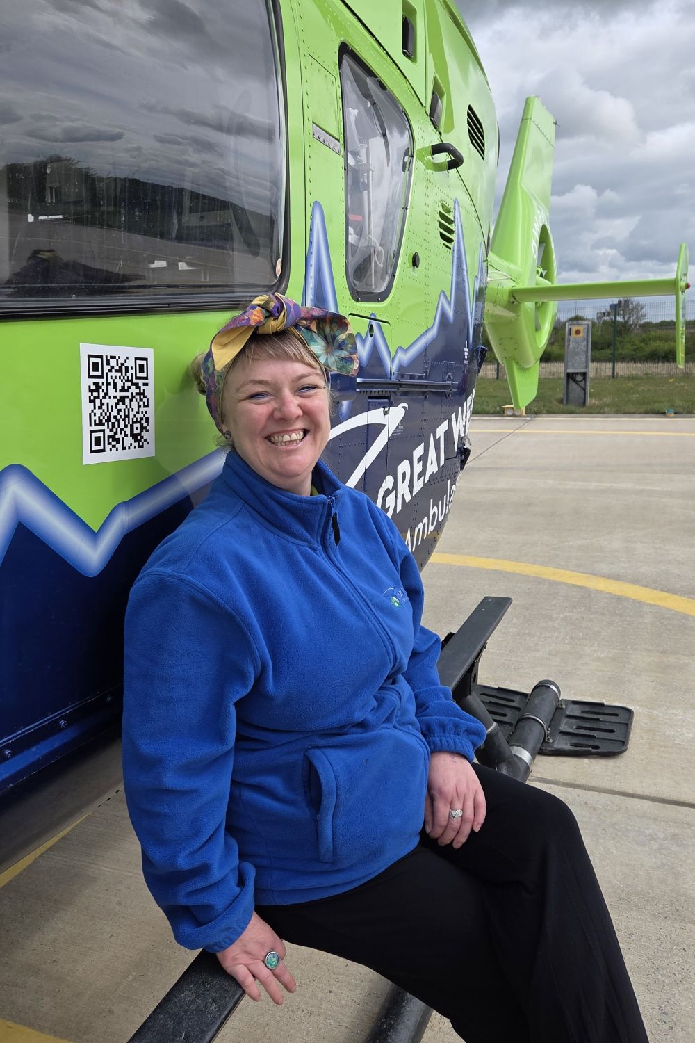 lottery canvasser in front of helicopter