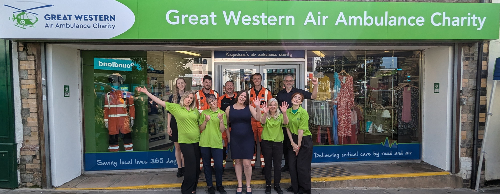 Great Western Ambulance Charity shop front with staff stood outside celebrating the opening of the new shop