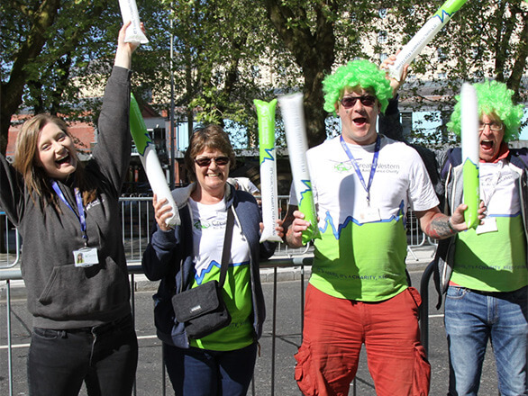 A group of GWAAC volunteers cheering at an event
