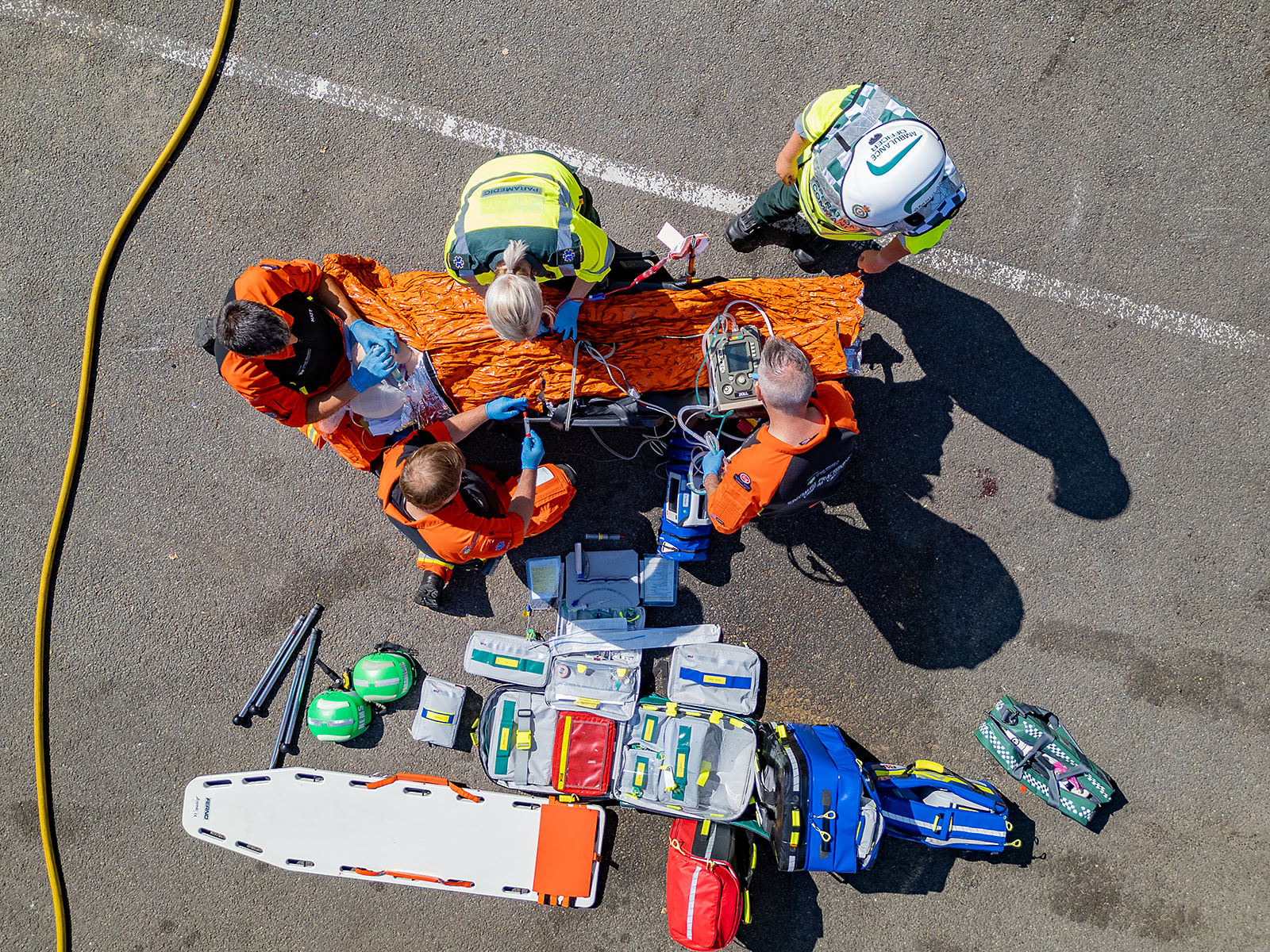 The GWAAC Critical Care Team walking away from the green and blue helicopter