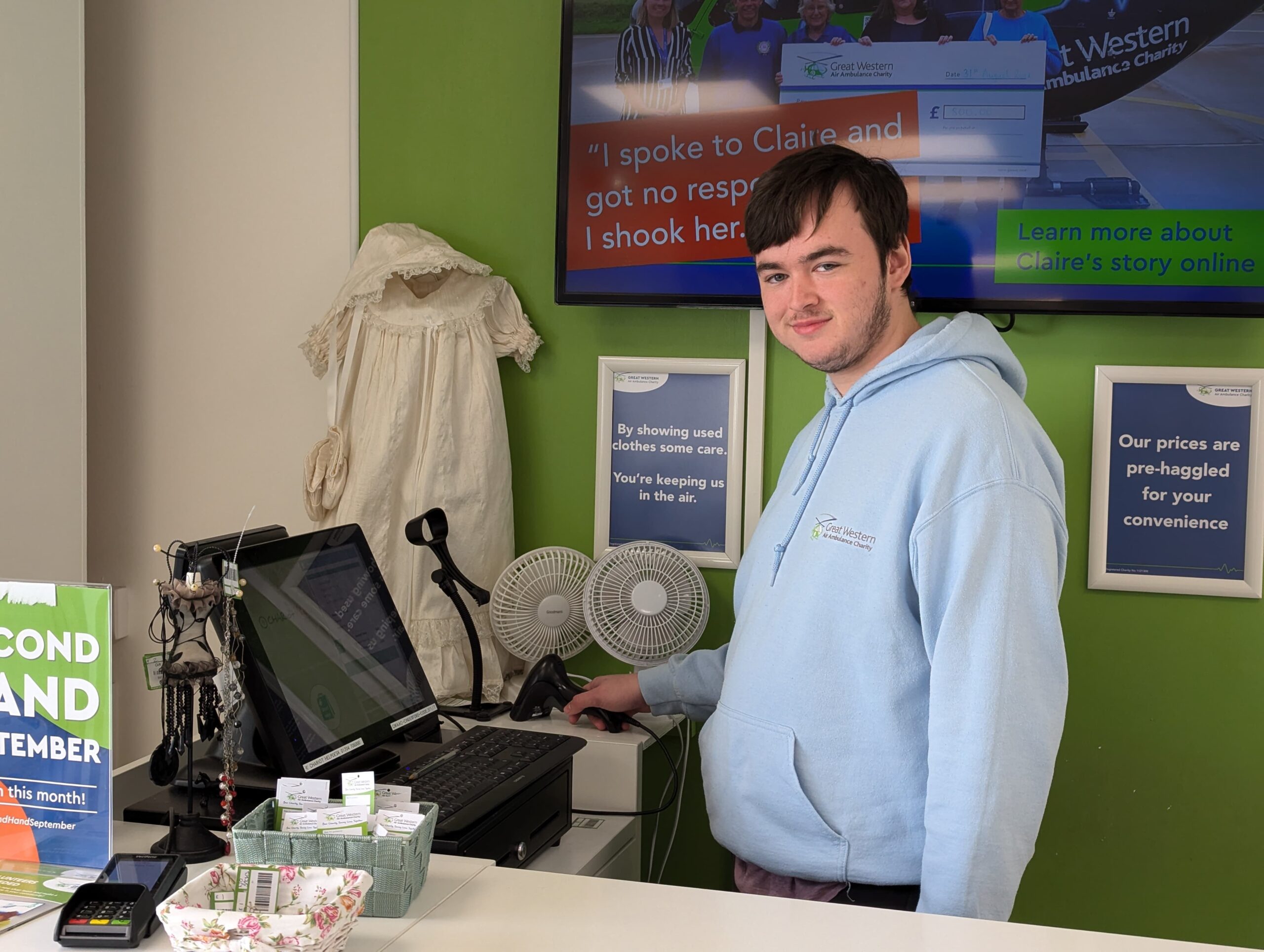 Luke posing at the till in GWAAC's Cinderford shop