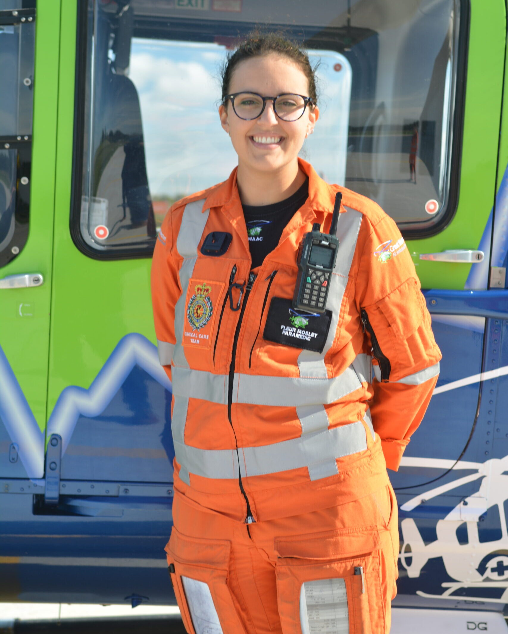 SPCC Fleur Mosley in uniform in front of the blue and green GWAAC helicopter