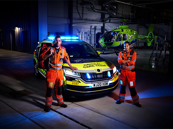 SPCCs Matt and Dee by a GWAAC critical care car and heli at night